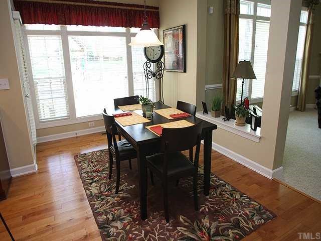 8316 Clarks Branch Drive Raleigh, NC 27613 - Photo 5 of 12 Kitchen eating area offers access to screened porch, wall of windows with 2-in plantation blinds and more hardwoods!
