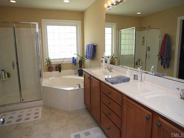 8316 Clarks Branch Drive Raleigh, NC 27613 - Photo 7 of 12 Large master bath with adult-height, dual vanity sinks, tile flooring, garden tub, separate shower, water closet and HUGE walk-in closet.