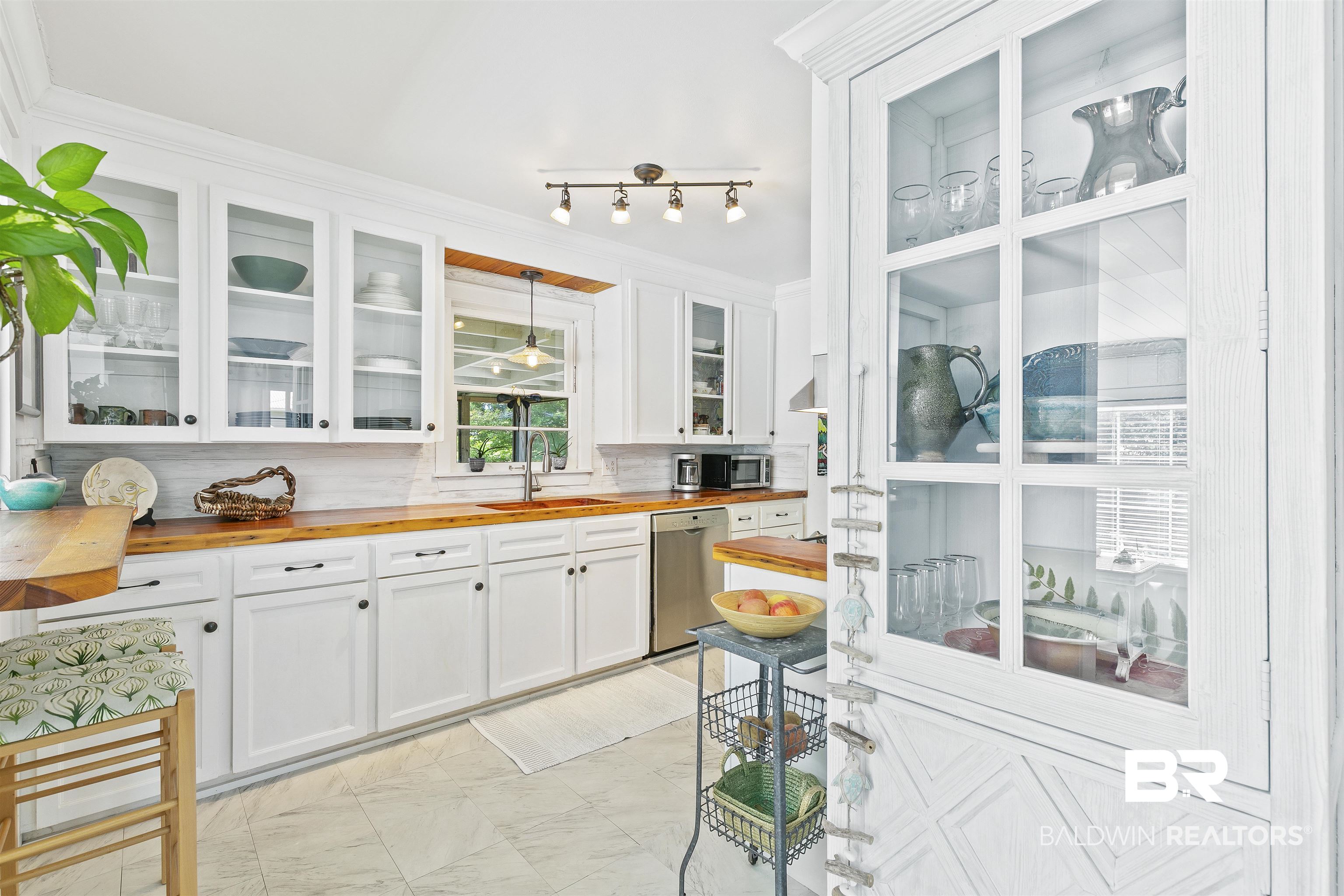 220 Pinecrest Lane Fairhope, AL 36532 - Photo 8 of 32 Kitchen with decorative backsplash, white cabinets, hanging light fixtures, appliances with stainless steel finishes, and wooden counters