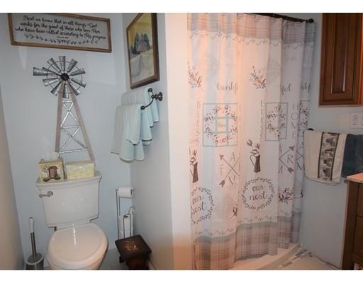 182 Cottage Street Athol, MA 01331 - Photo 8 of 28 a bathroom with a toilet and a shower curtain
