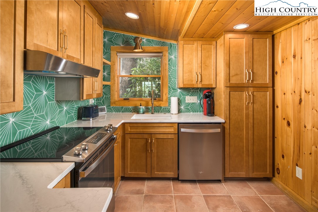 280 Chinkapin Ridge Road Seven Devils, NC 28604 - Photo 14 of 36 a kitchen with stainless steel appliances granite countertop a sink a stove and a refrigerator