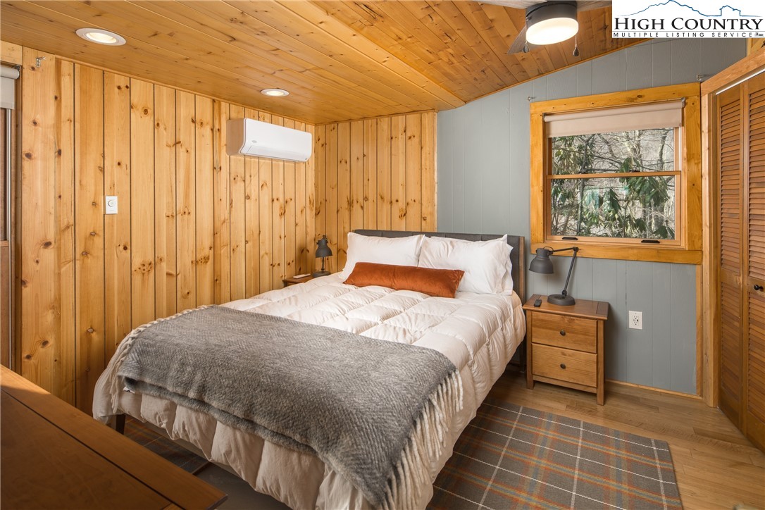 280 Chinkapin Ridge Road Seven Devils, NC 28604 - Photo 17 of 36 a bedroom with a bed and a window