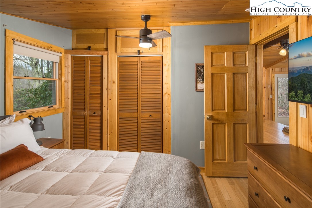 280 Chinkapin Ridge Road Seven Devils, NC 28604 - Photo 18 of 36 a bedroom with a bed and wooden floor