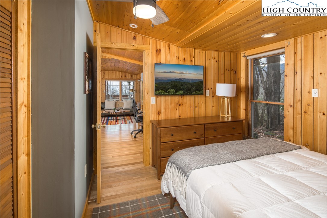 280 Chinkapin Ridge Road Seven Devils, NC 28604 - Photo 19 of 36 a bedroom with a bed and a flat screen tv