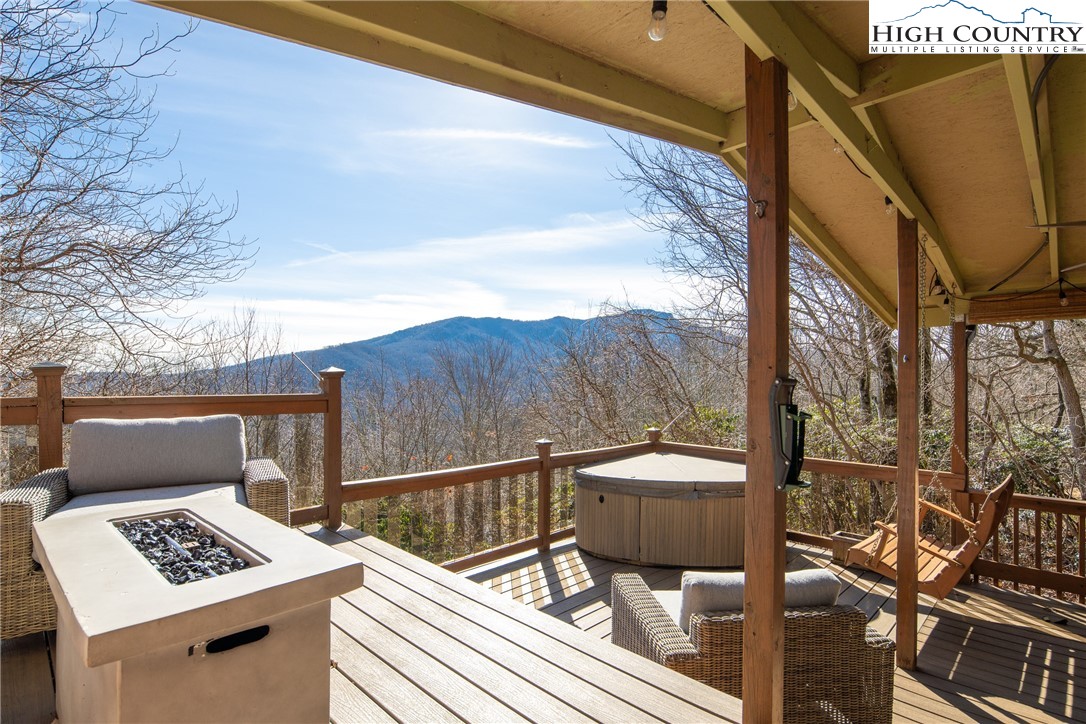 280 Chinkapin Ridge Road Seven Devils, NC 28604 - Photo 22 of 36 a view of a balcony with chairs and wooden floor