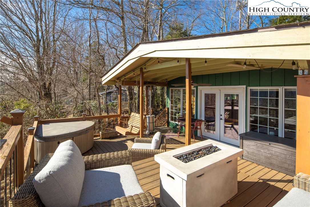 280 Chinkapin Ridge Road Seven Devils, NC 28604 - Photo 24 of 36 a view of a patio with couches table and chairs and potted plants