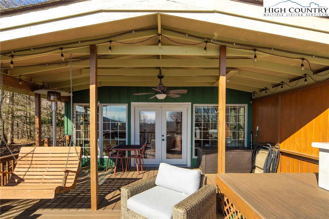 280 Chinkapin Ridge Road Seven Devils, NC 28604 - Photo 25 of 36 a view of a patio with a table and chairs