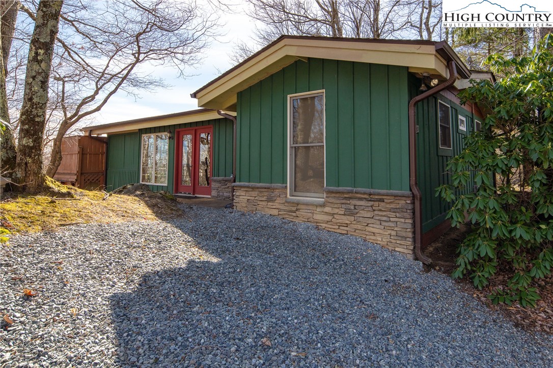 280 Chinkapin Ridge Road Seven Devils, NC 28604 - Photo 3 of 36 a front view of a house with a yard and garage