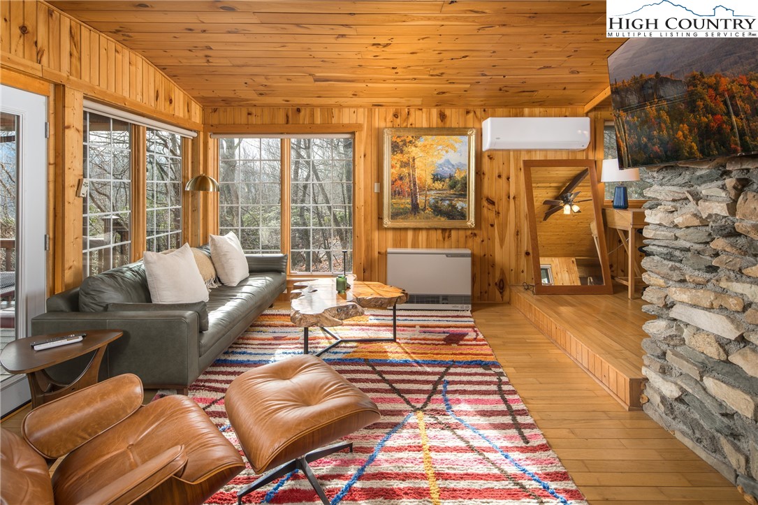 280 Chinkapin Ridge Road Seven Devils, NC 28604 - Photo 5 of 36 a living room with furniture and a floor to ceiling window