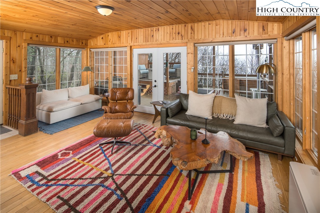 280 Chinkapin Ridge Road Seven Devils, NC 28604 - Photo 6 of 36 a living room filled with furniture and a floor to ceiling window