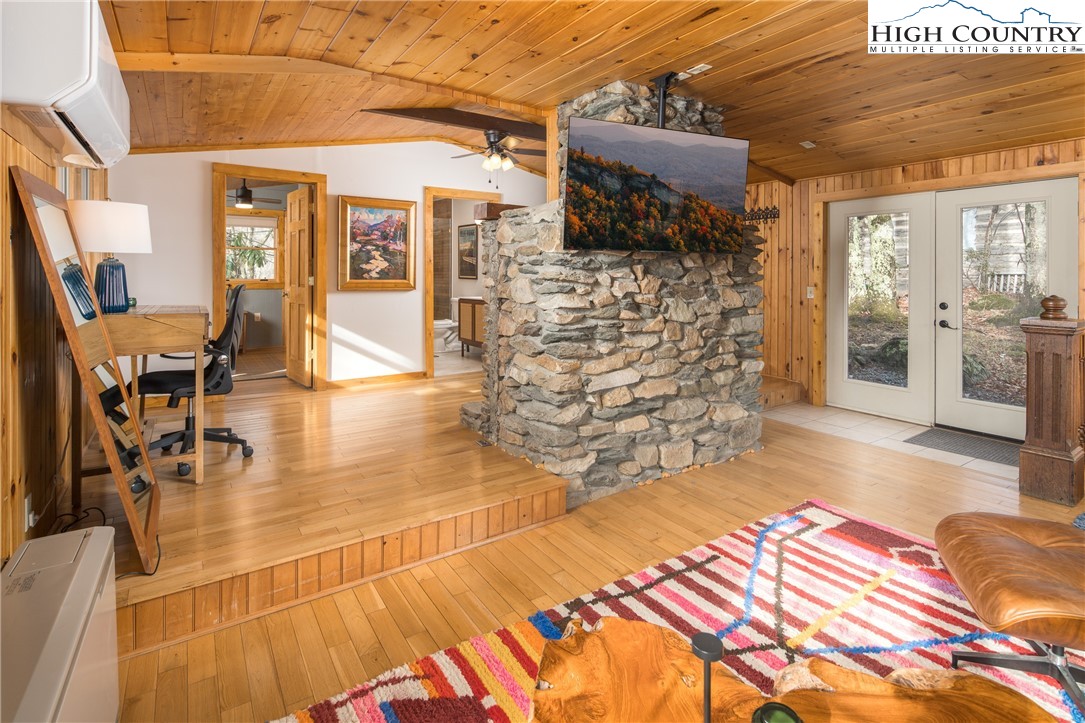 280 Chinkapin Ridge Road Seven Devils, NC 28604 - Photo 8 of 36 a bedroom with a bed and wooden floor