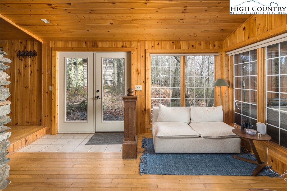 280 Chinkapin Ridge Road Seven Devils, NC 28604 - Photo 10 of 36 a living room with furniture large window and wooden floor