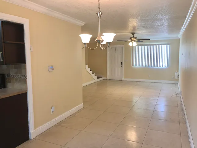 a view of a chandelier fan and refrigerator in a kitchen