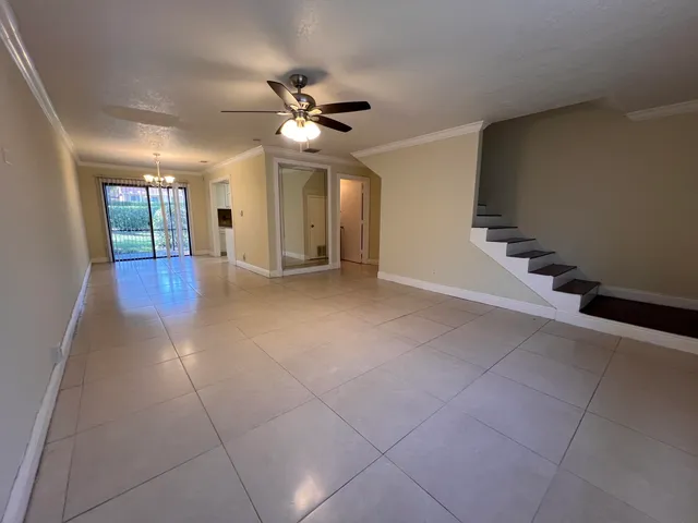 a view of a livingroom with a ceiling fan and window