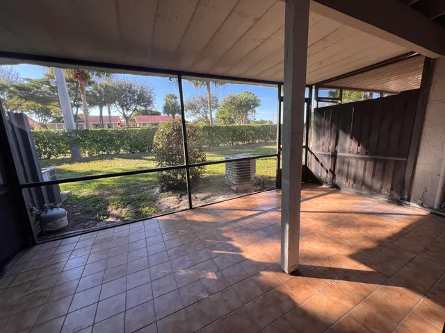 a view of a porch with a floor to ceiling window fire pit and a yard