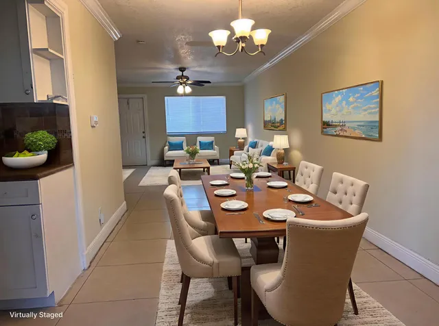 a view of a dining room with furniture a chandelier and wooden floor