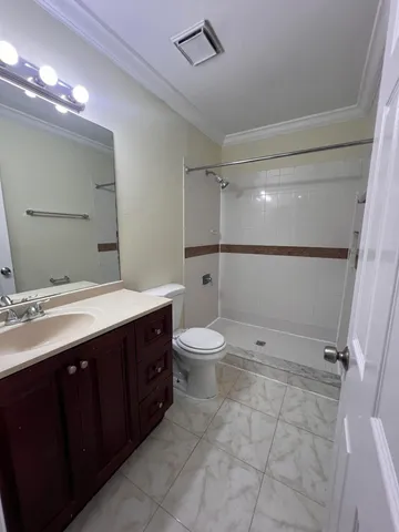 a bathroom with a double vanity sink toilet and shower
