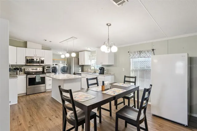 a kitchen with a stove a refrigerator and a microwave