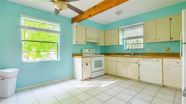 a kitchen that has a sink and a stove