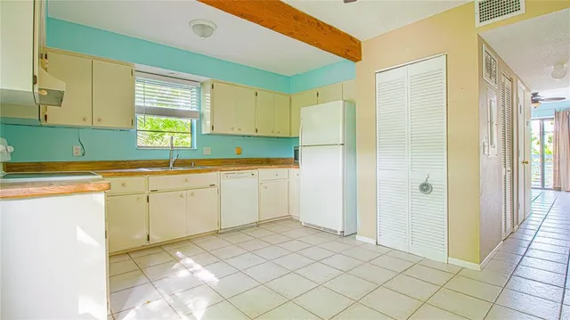 a kitchen with a sink cabinets and window