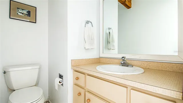 a bathroom with a sink toilet and vanity