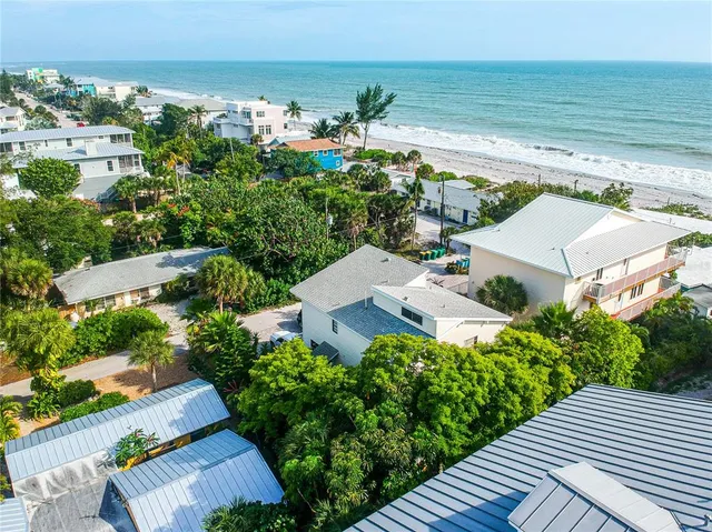 an aerial view of a house with a ocean view