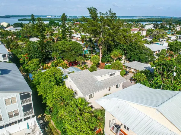 an aerial view of multiple houses with yard
