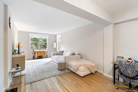 a bedroom with furniture and a wooden floor