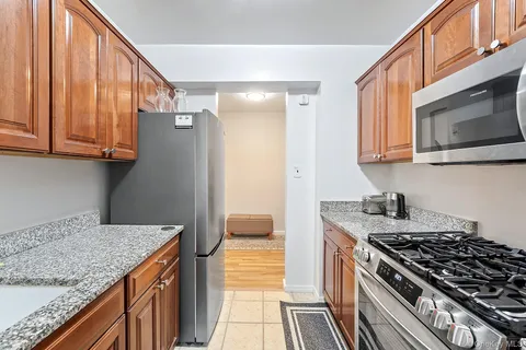 a kitchen with stainless steel appliances granite countertop a stove and a microwave