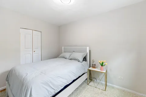 a bedroom with a bed and a table