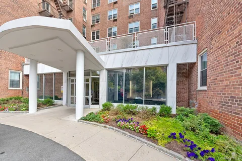 a front view of a building with a garden