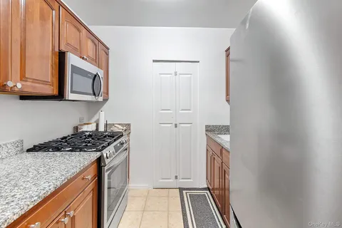 a kitchen with stainless steel appliances granite countertop a stove and a microwave