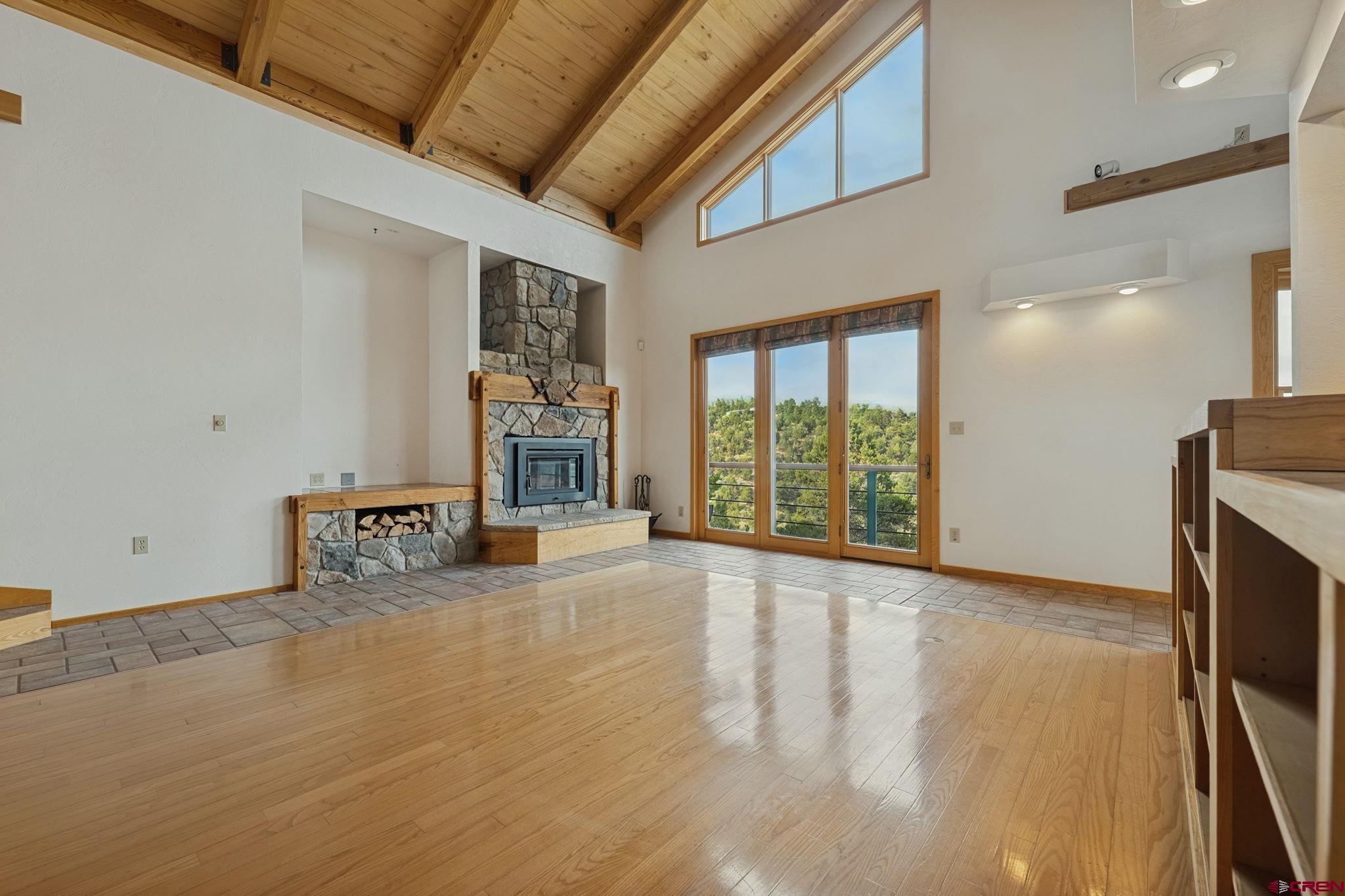 481 Far View Road Durango, CO 81303 - Photo 13 of 44 a view of an empty room with a fireplace and a large window