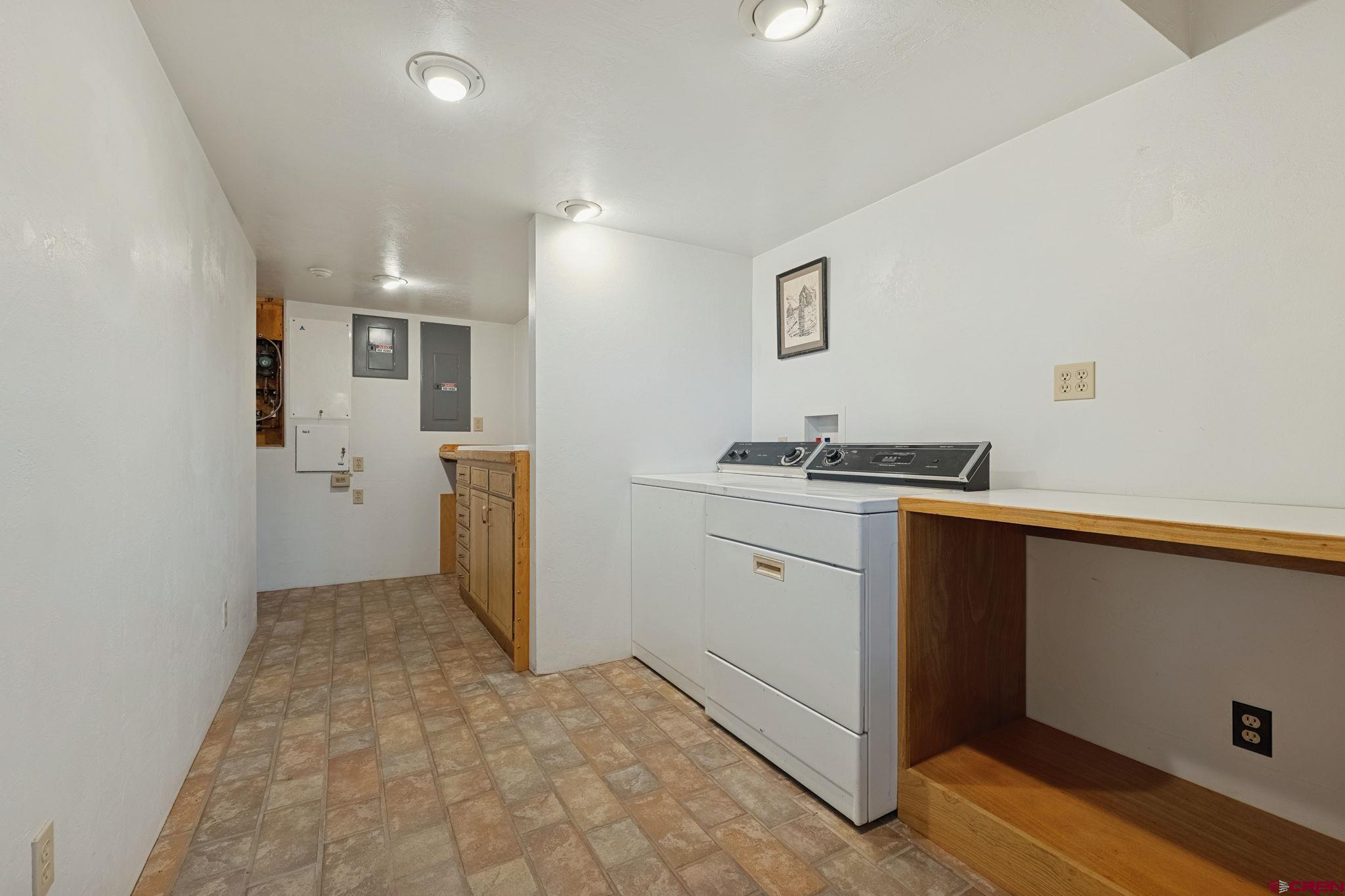 481 Far View Road Durango, CO 81303 - Photo 34 of 44 a view of a kitchen with refrigerator and white cabinets