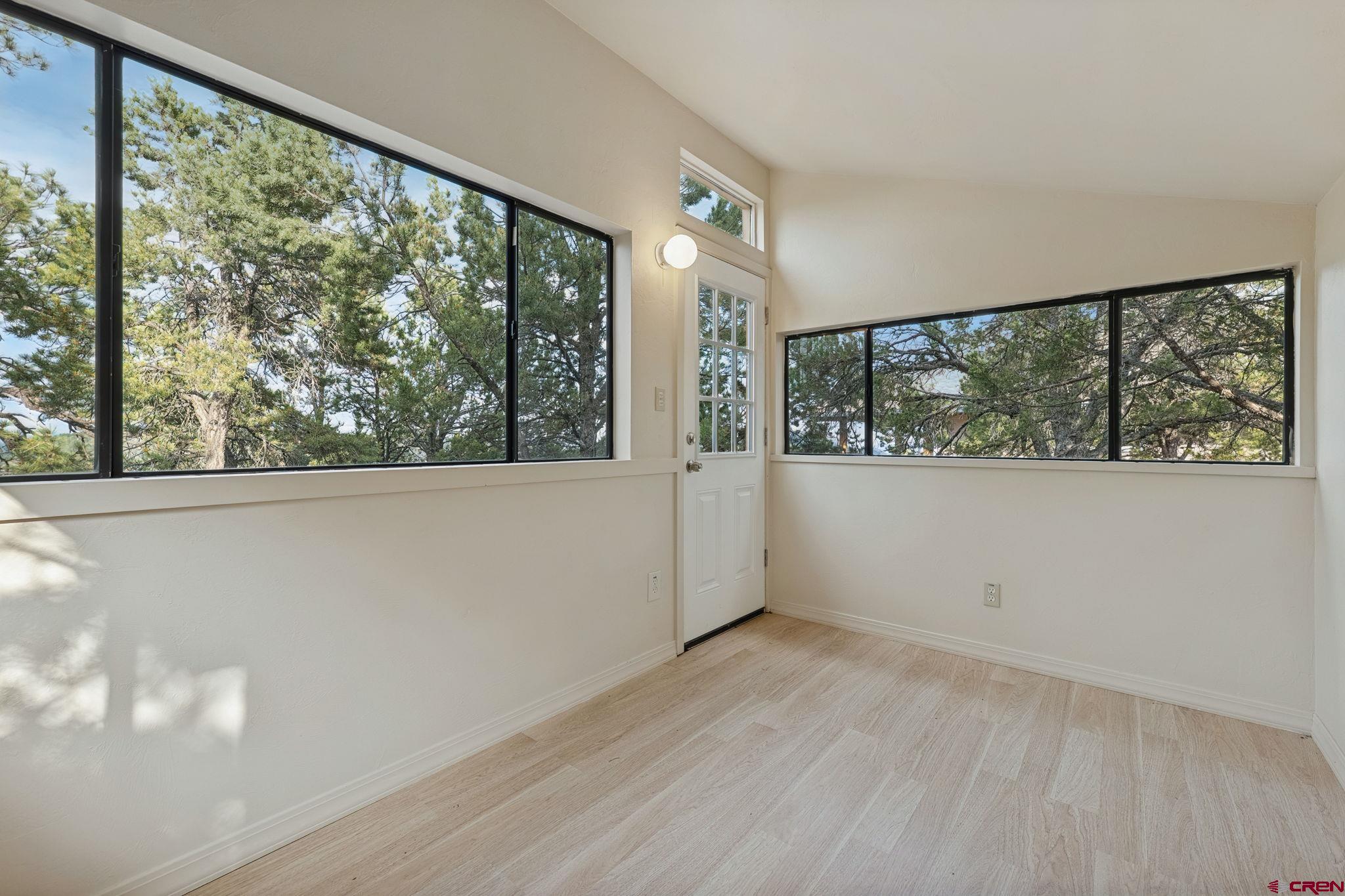 481 Far View Road Durango, CO 81303 - Photo 37 of 44 a view of an empty room with wooden floor and a window
