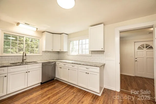 a kitchen with a sink cabinets and window