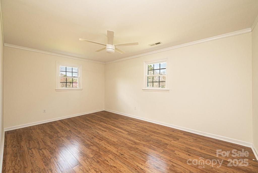 1993 Moss Farm Road Hickory, NC 28602 - Photo 26 of 36 an empty room with wooden floor windows and ceiling fan