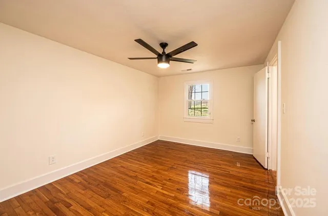 a view of a room with wooden floor