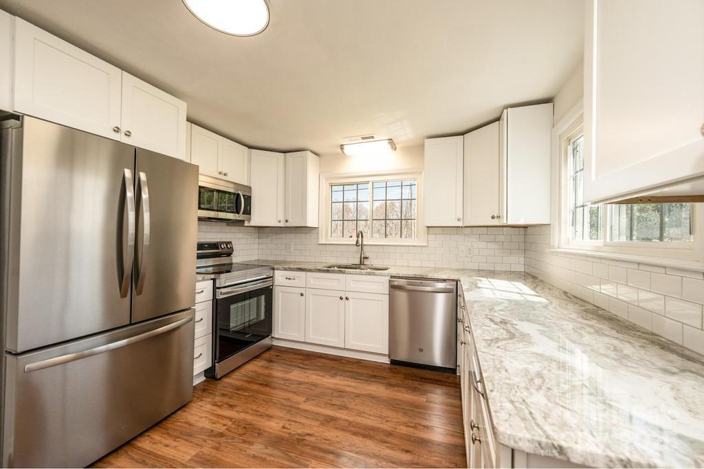 1993 Moss Farm Road Hickory, NC 28602 - Photo 8 of 36 a kitchen with stainless steel appliances granite countertop a refrigerator a stove a sink and a microwave