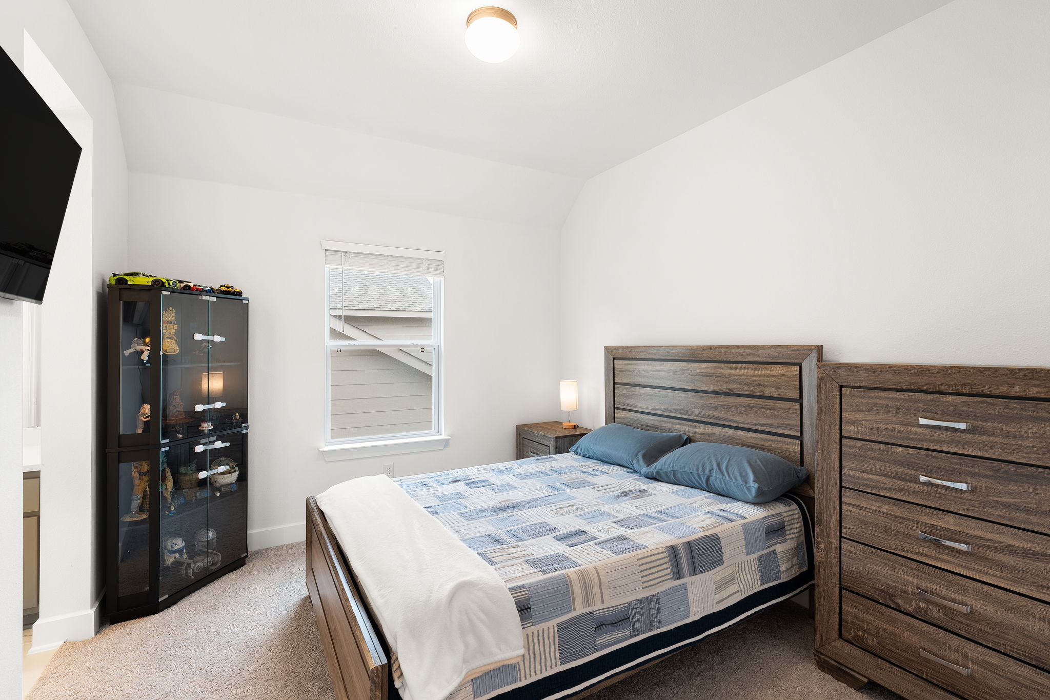 515 Watershield Cove Georgetown, TX 78633 - Photo 27 of 40 A well-lit bedroom offering a cozy, inviting atmosphere with ample natural light.