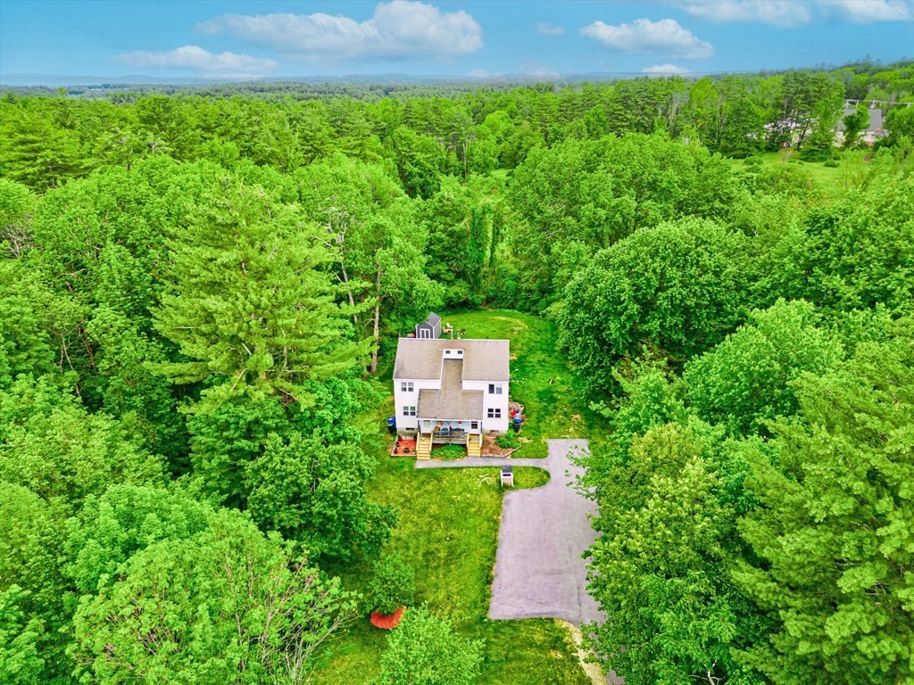 an aerial view of a house with a yard
