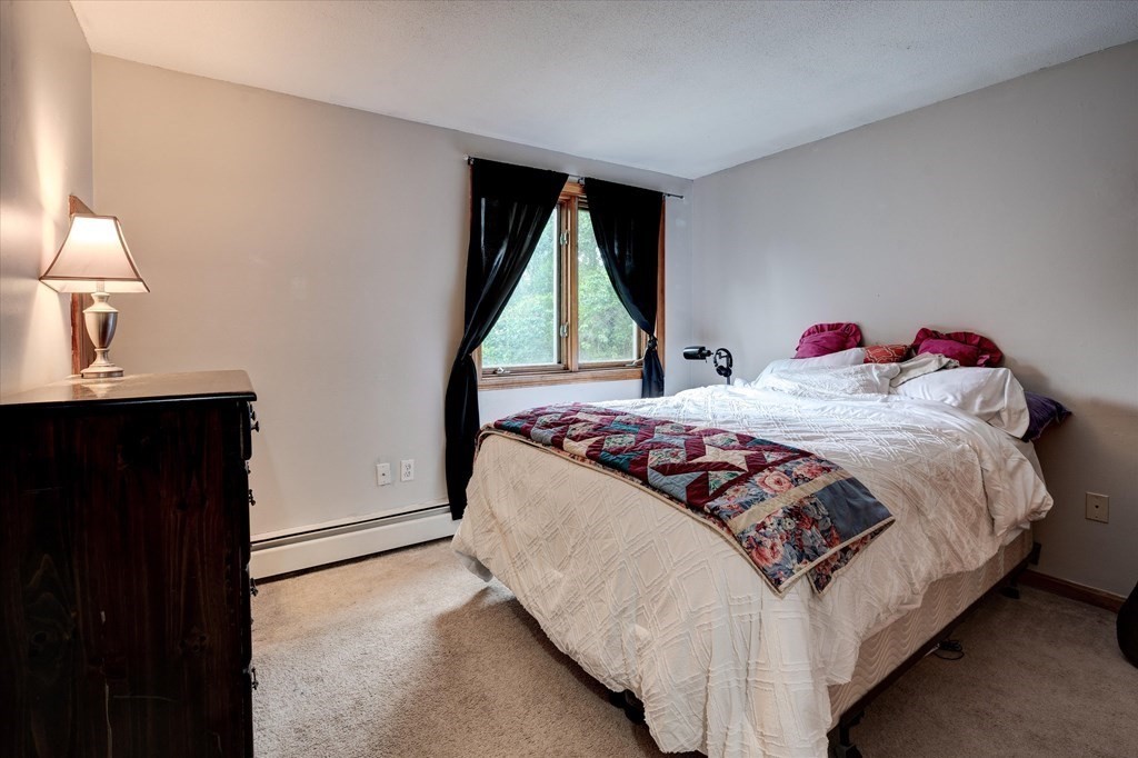 6 Litchfield Road, Unit A Londonderry, NH 03053 - Photo 13 of 28 a bedroom with a bed and a window