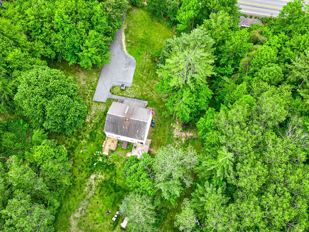 6 Litchfield Road, Unit A Londonderry, NH 03053 - Photo 21 of 28 an aerial view of a house with a yard and trees all around