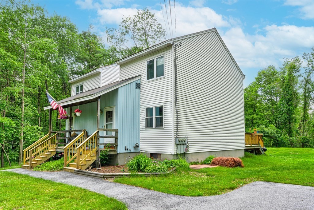 6 Litchfield Road, Unit A Londonderry, NH 03053 - Photo 22 of 28 a front view of a house with garden