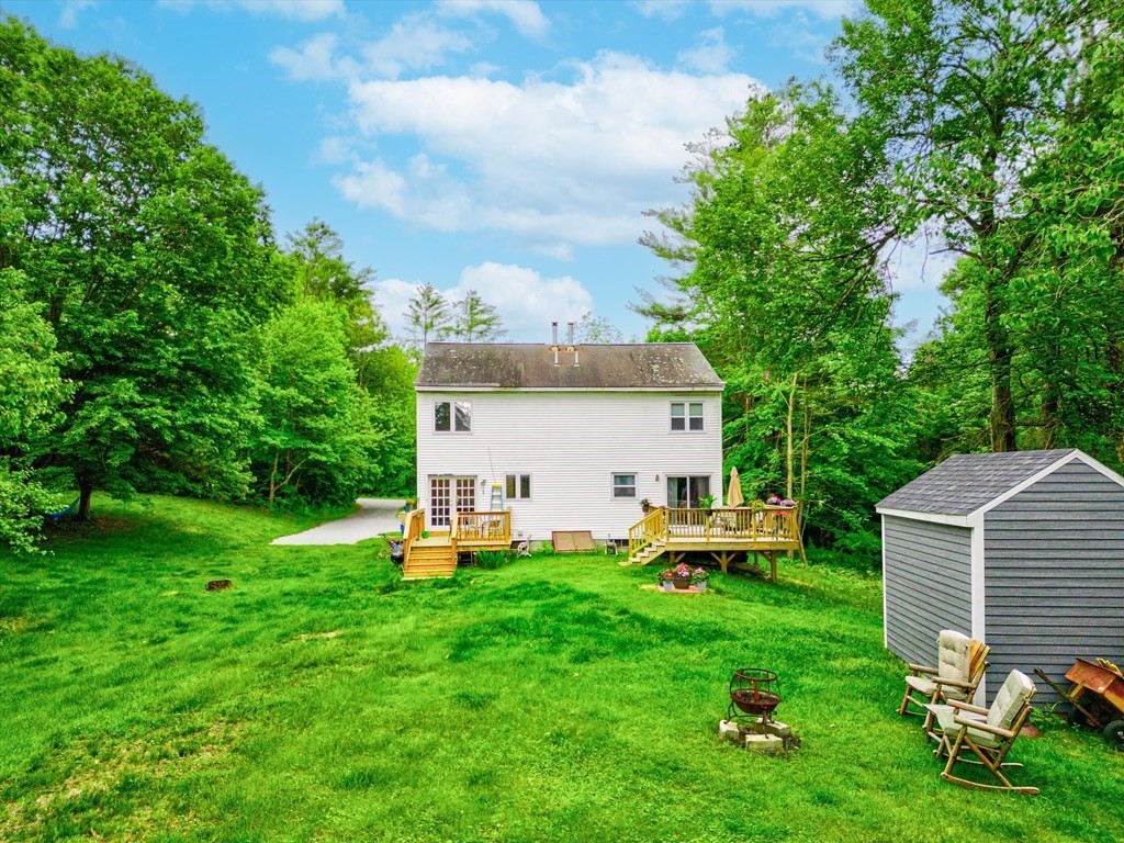 6 Litchfield Road, Unit A Londonderry, NH 03053 - Photo 25 of 28 a view of a house with a backyard porch and sitting area