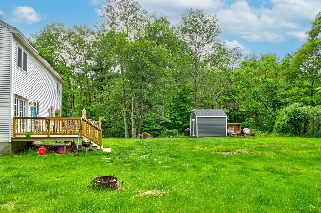 6 Litchfield Road, Unit A Londonderry, NH 03053 - Photo 27 of 28 a view of a house with backyard and sitting area