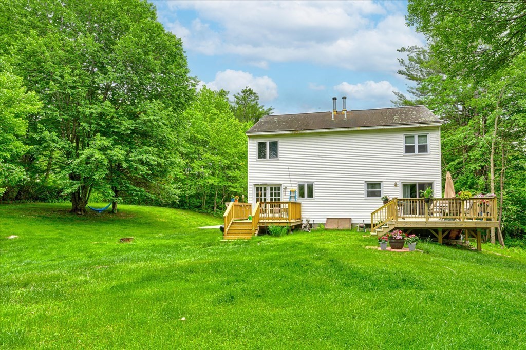 6 Litchfield Road, Unit A Londonderry, NH 03053 - Photo 3 of 28 a view of a house with a backyard