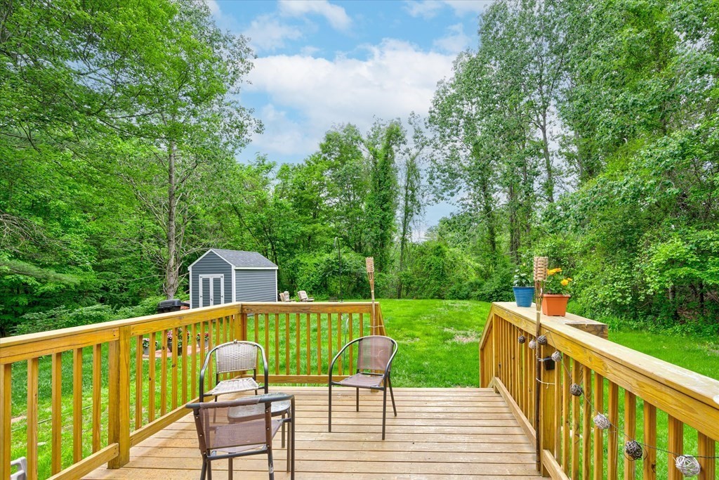 6 Litchfield Road, Unit A Londonderry, NH 03053 - Photo 7 of 28 a view of a deck with couches chairs and wooden fence
