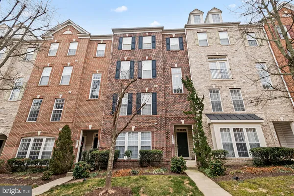 a front view of a residential apartment building with a yard