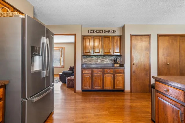 a kitchen with stainless steel appliances granite countertop a refrigerator stove top oven and sink